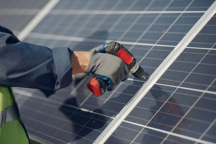 Solar panel installation on a residential rooftop in Ahmedabad, Gujarat, under a clear sky